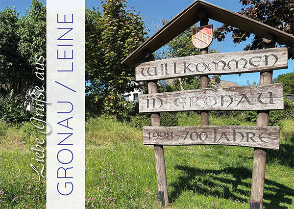 Postkarte mit dem Schriftzug Willkommen in Gronau und einem Bild des Ortsschildes